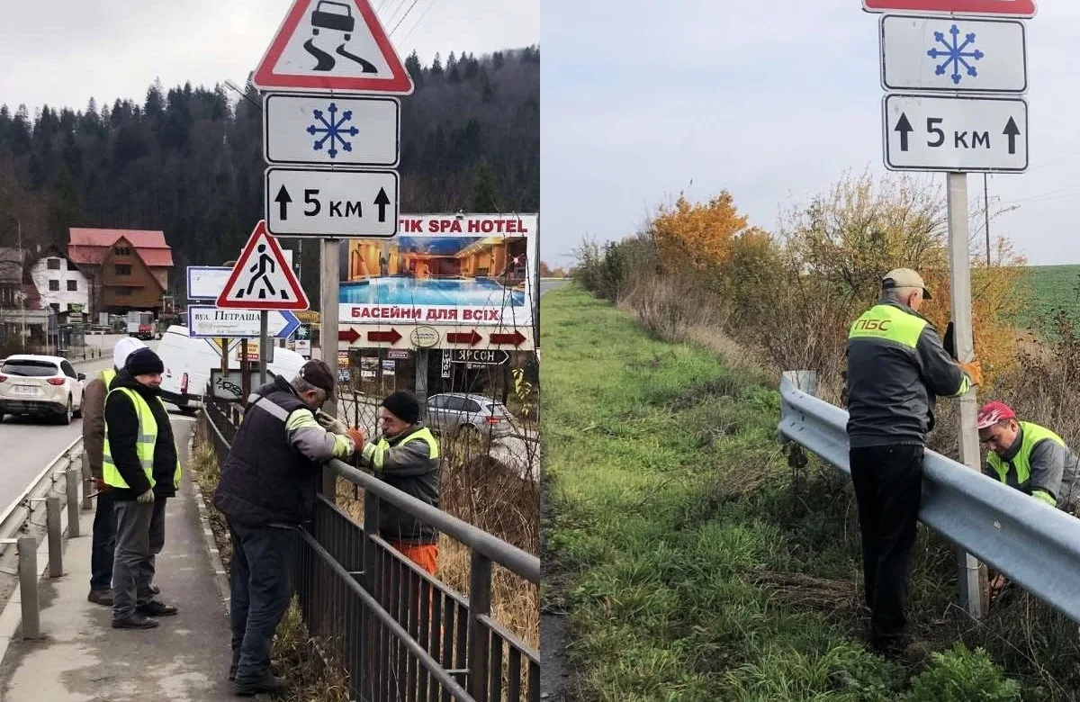 Робітники встановлюють дорожні знаки вздовж траси