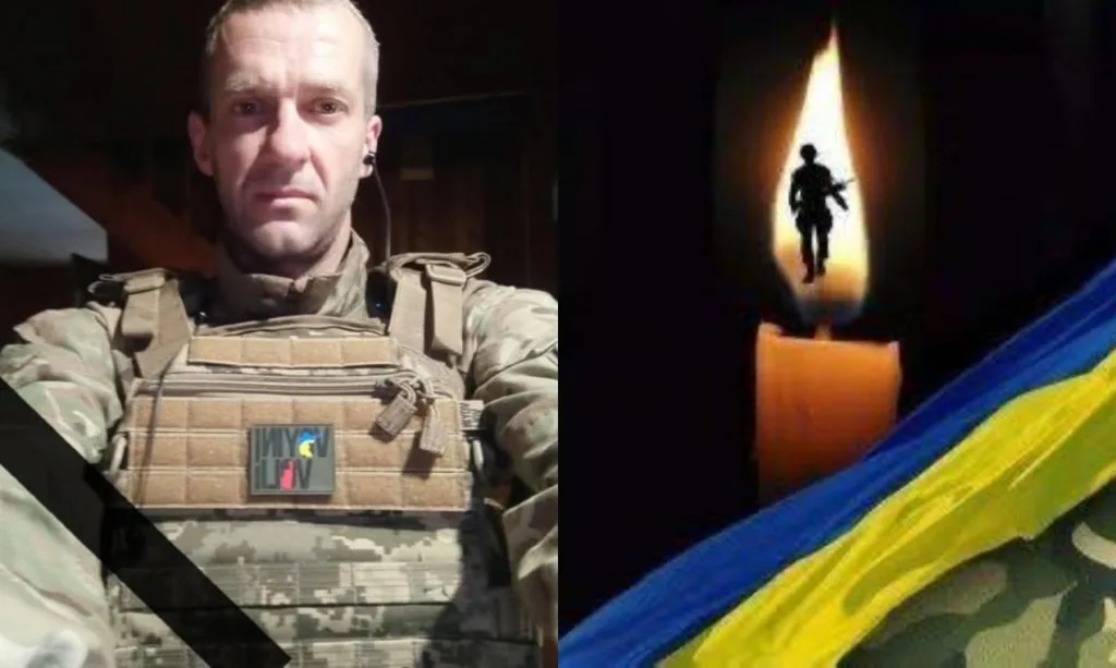 Український військовий та свічка пам’яті з прапором