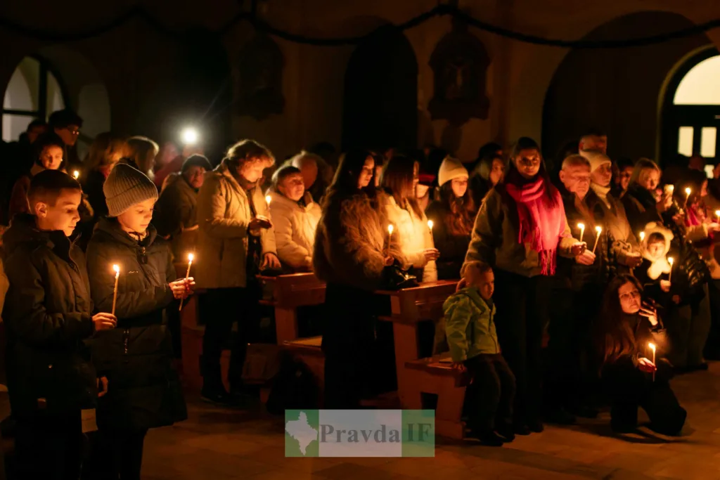 Люди тримають свічки під час вечірньої молитви