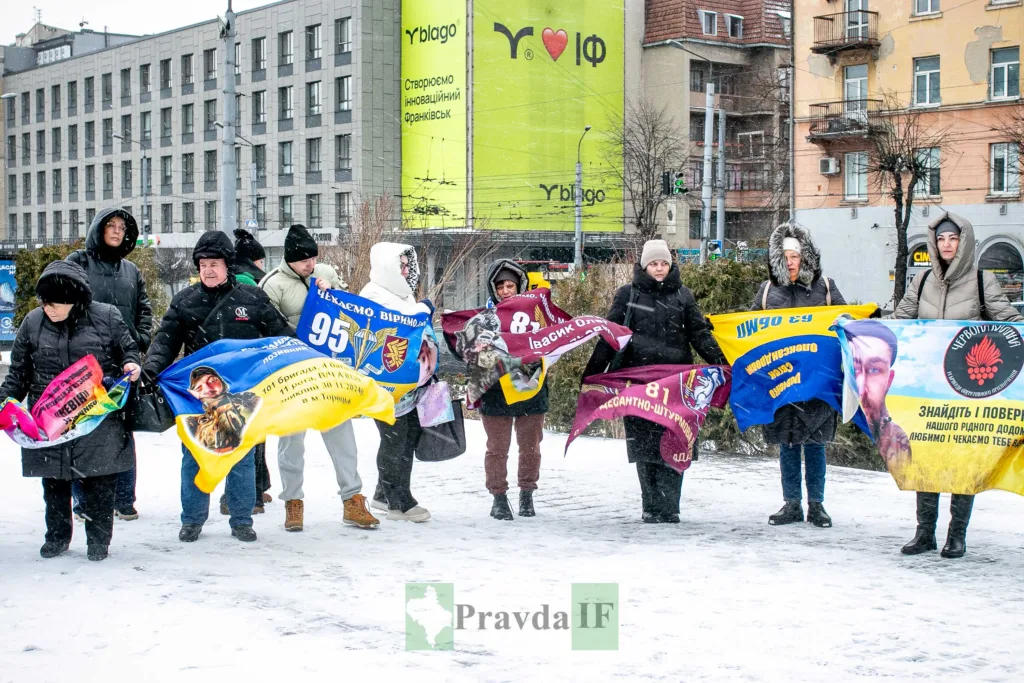 Люди тримають прапори з підтримкою військових на площі