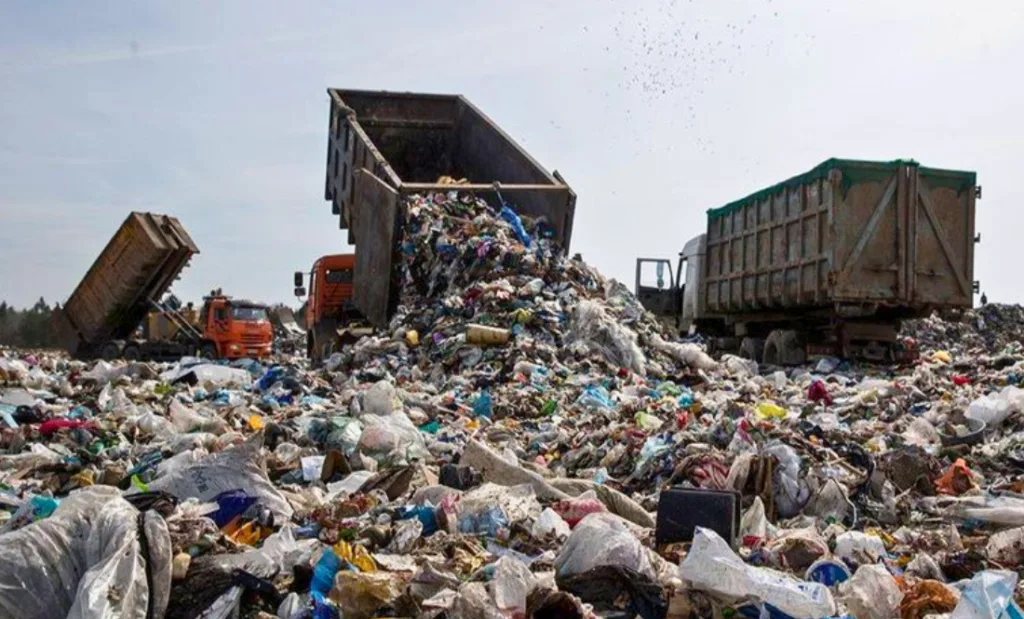 Вантажівки вивантажують сміття на звалище