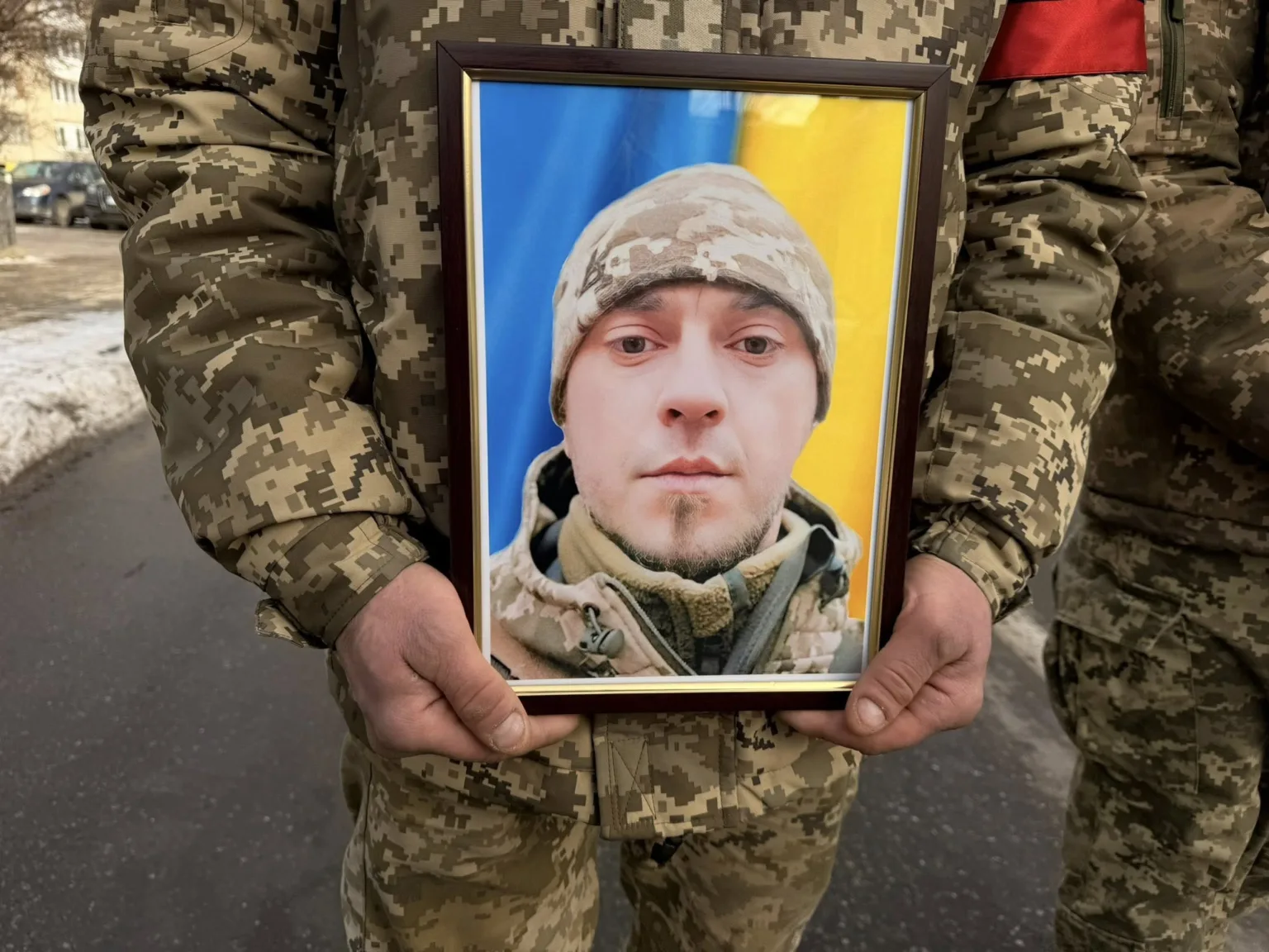 Військовий тримає фото загиблого солдата