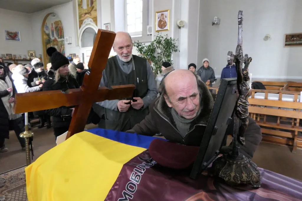 Прощання у церкві з українським прапором