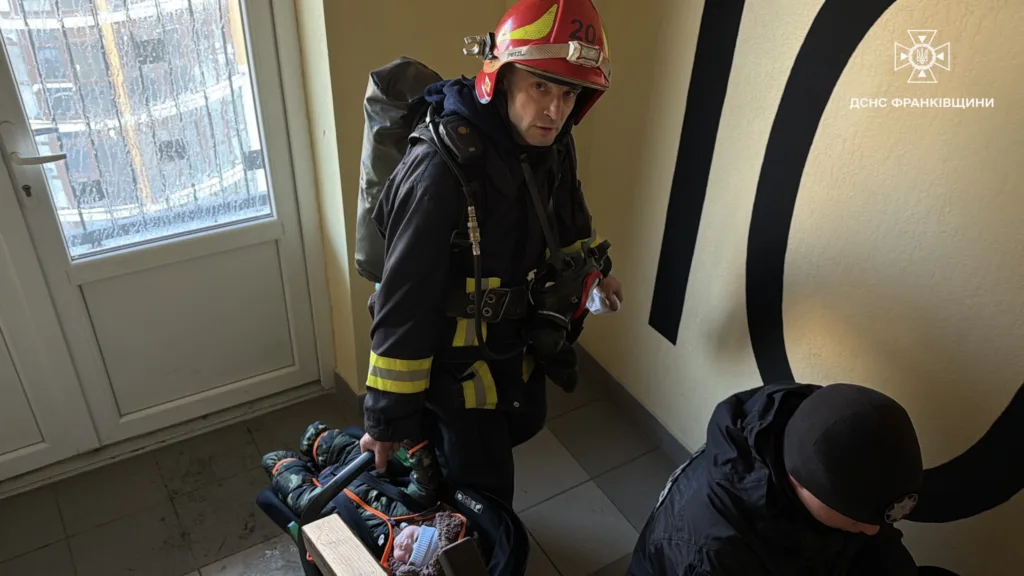 Рятувальник несе немовля у багатоповерхівці