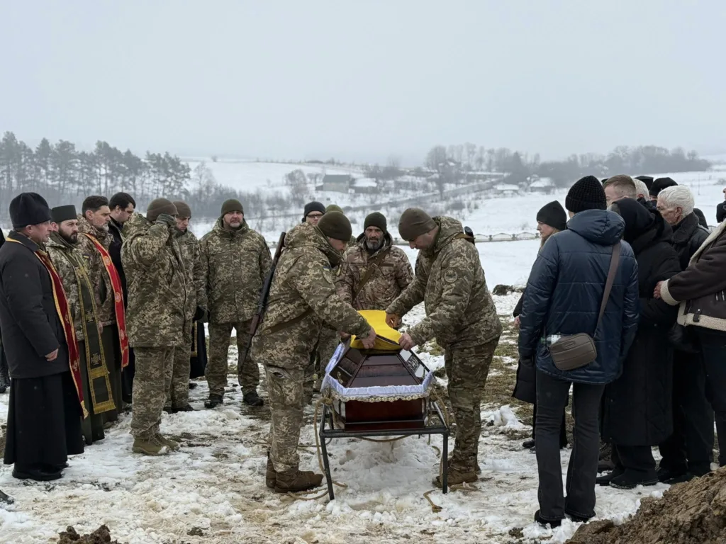 Військові та священники на похороні воїна взимку