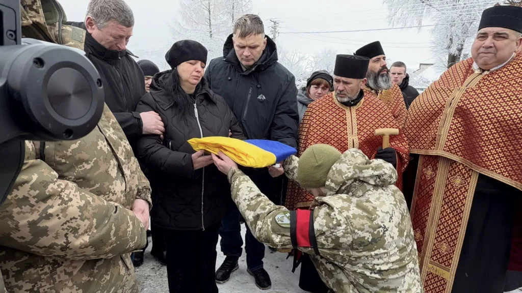 Військові передають прапор родині загиблого героя
