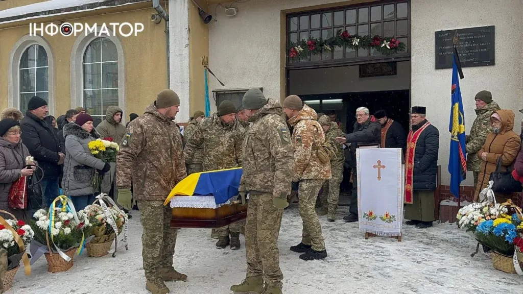 Військові несуть труну з українським прапором