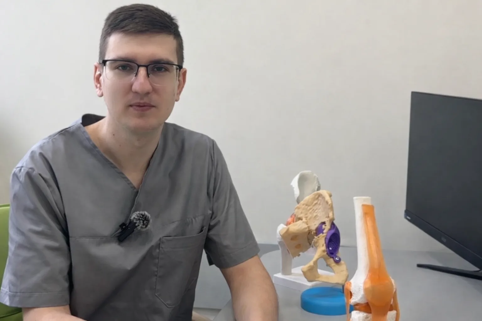 Медик пояснює анатомію з моделями суглобів