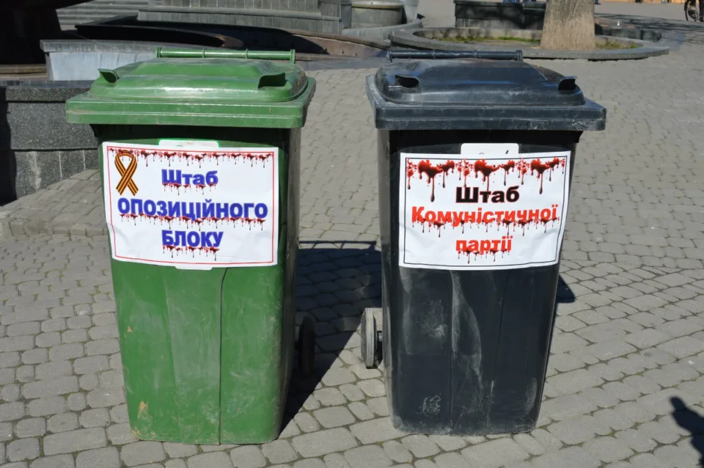 Дві смітники з політичними плакатами на вулиці