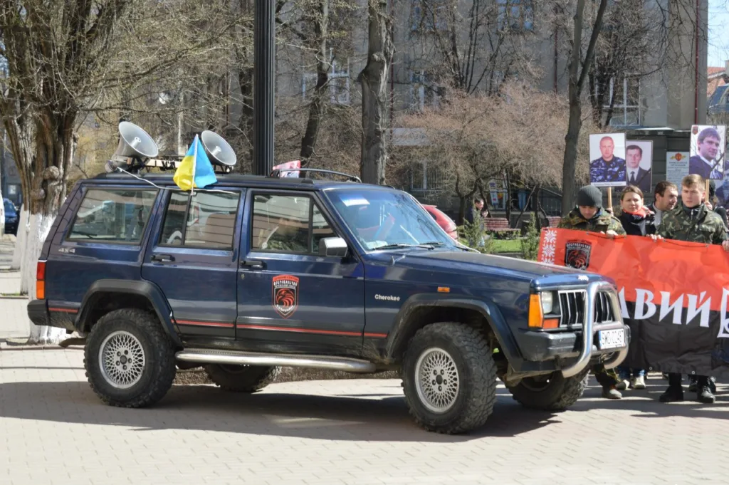 Автомобіль з українським прапором на міській вулиці