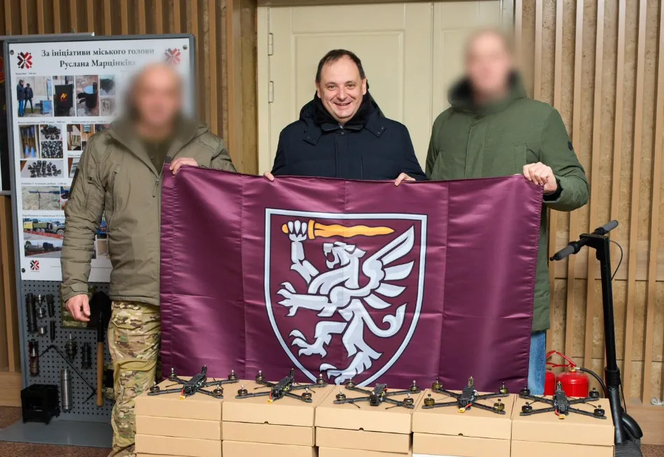 Люди тримають прапор із гербом лева