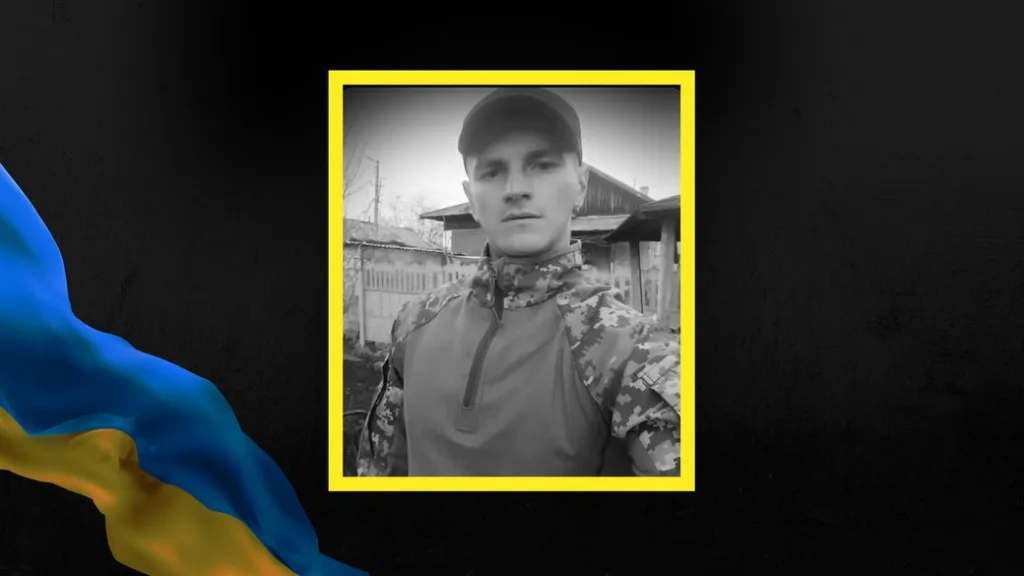 Український військовий у камуфляжі перед будинком