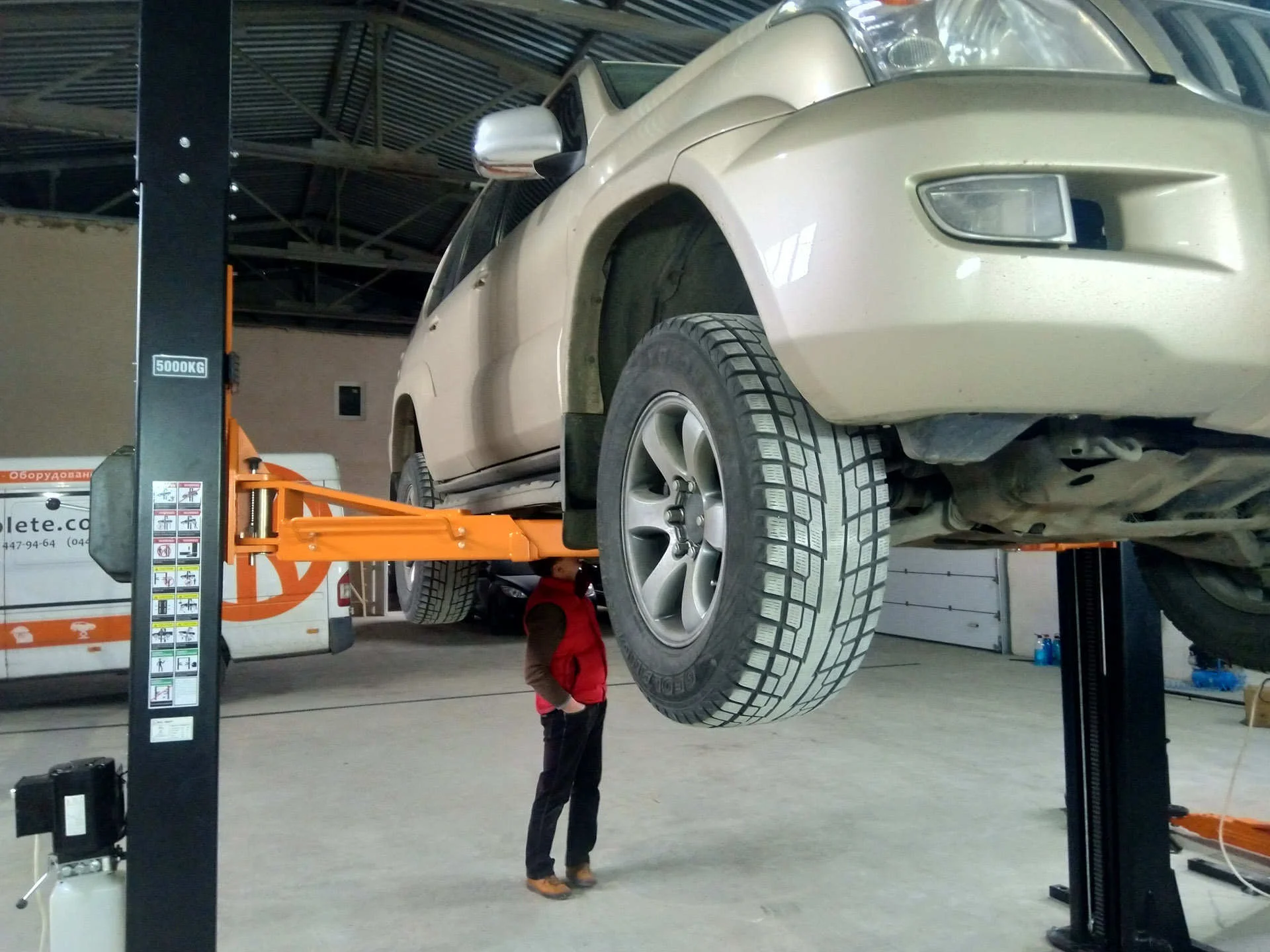 Автомобіль піднятий на підйомнику в автосервісі