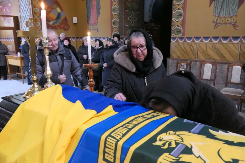 Прощання з військовим під українським прапором у церкві