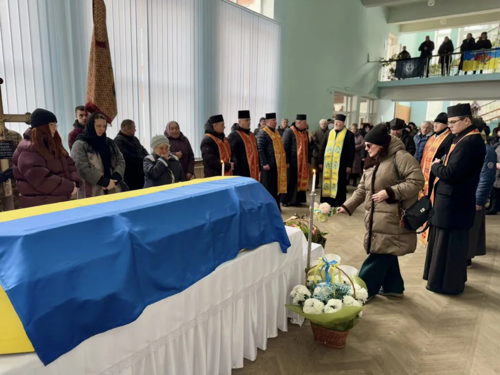 Прощання з полеглим воїном під українським прапором