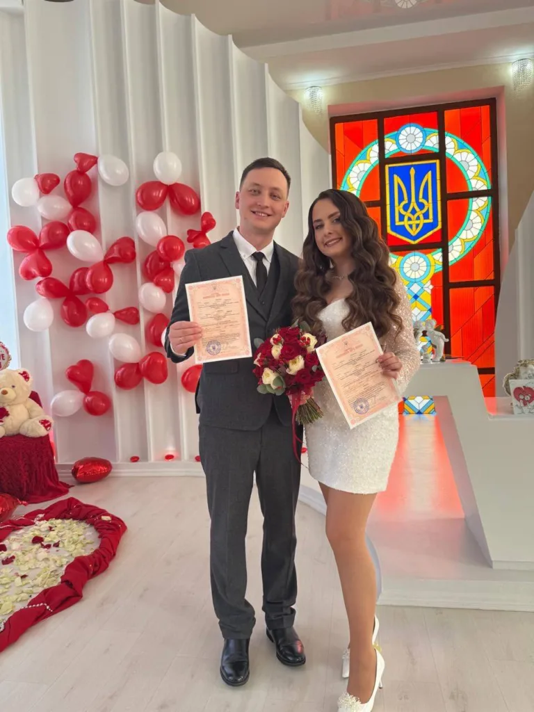 Молодята тримають свідоцтва про шлюб у РАЦСі