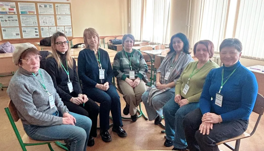 Група жінок сидить у класній кімнаті