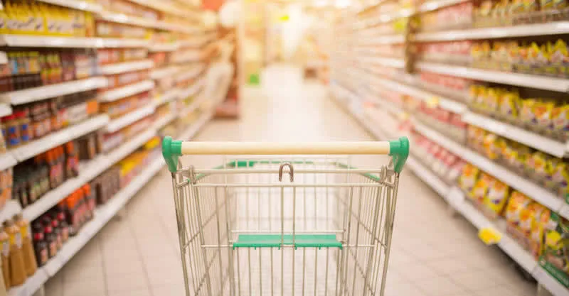 Порожній візок у супермаркеті між полицями товарів