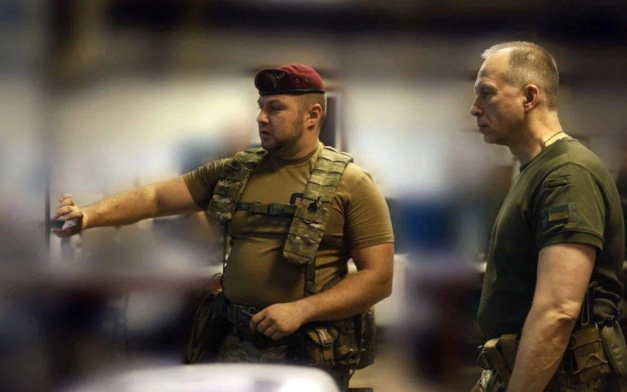 Двоє українських військових у формі обговорюють завдання