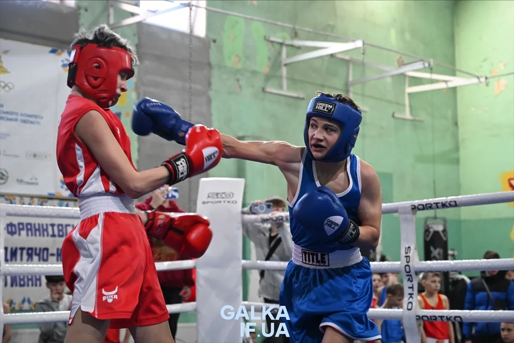 Боксери у синій і червоній формі під час бою