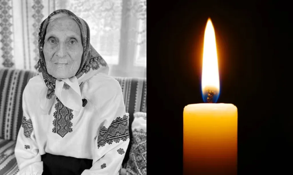 Похилий жінка у вишиванці та палаюча свічка