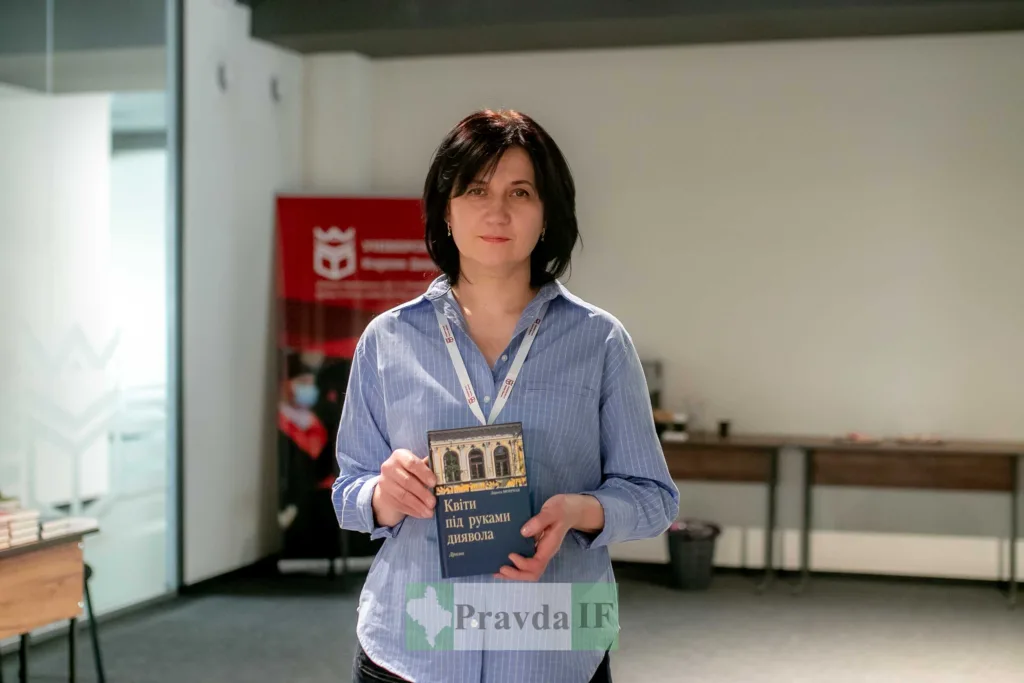 Жінка тримає книгу у сучасному офісі