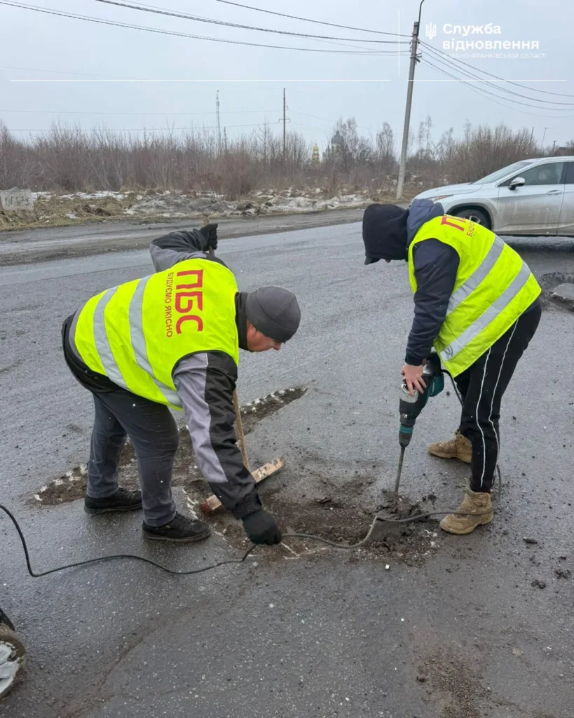 Робітники ремонтують дорожнє покриття взимку