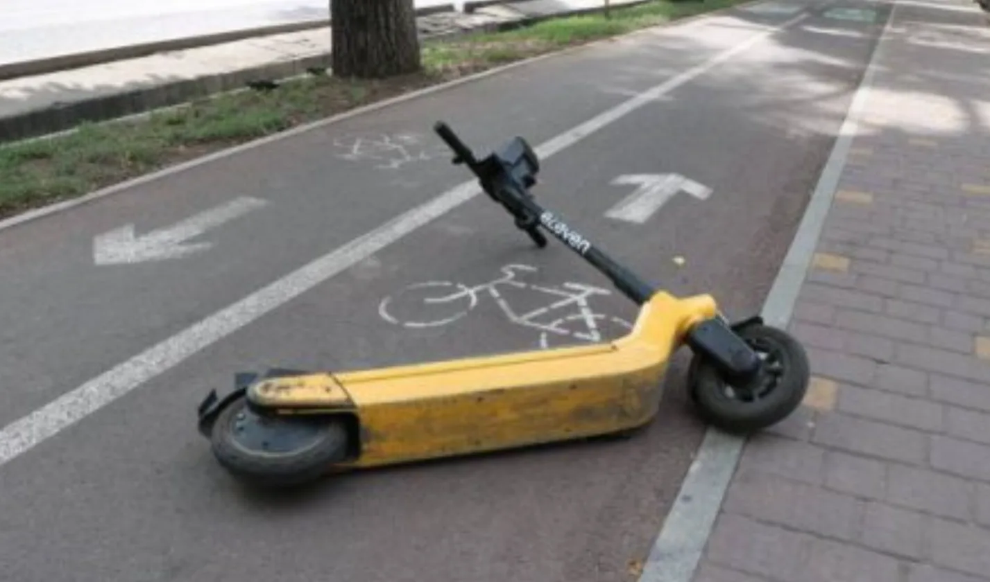 Перекинутий електросамокат на велосипедній доріжці
