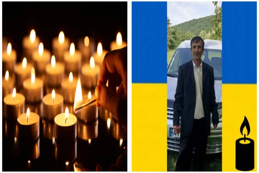 Запалені свічки пам’яті та чоловік на фоні прапора