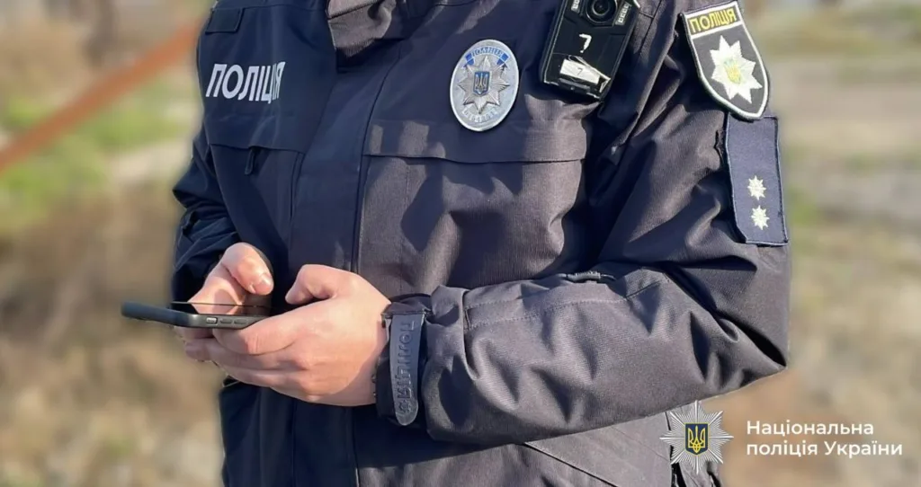Поліцейський України тримає телефон