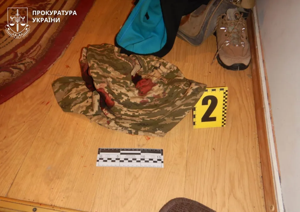 Камуфляжний одяг зі слідами крові на підлозі