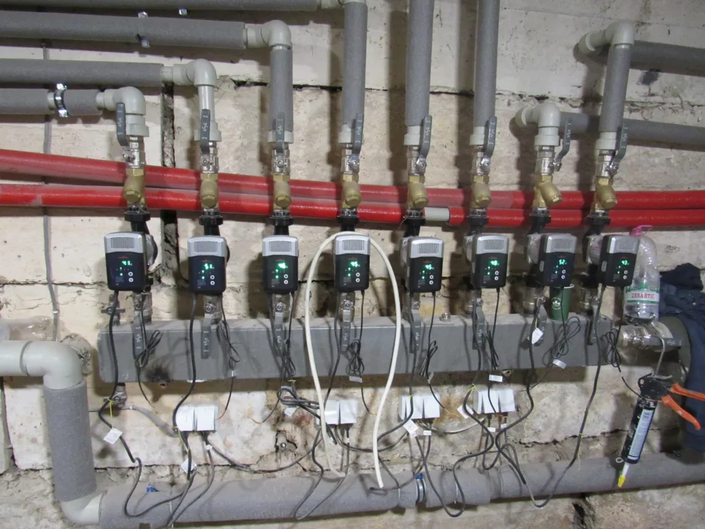 Система труб і насосів опалення у підвалі