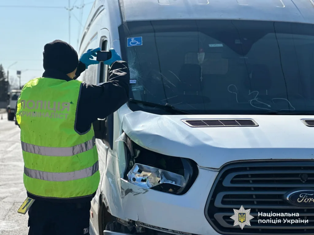 Криміналіст поліції фотографує пошкоджений мікроавтобус