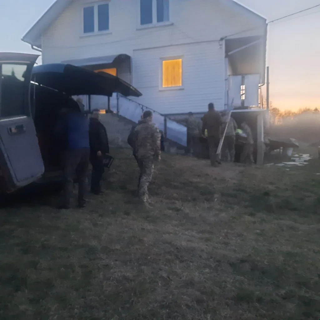 Люди біля будинку під час вечірньої роботи