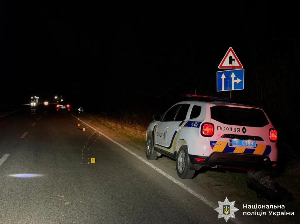 Поліцейський автомобіль на місці ДТП вночі