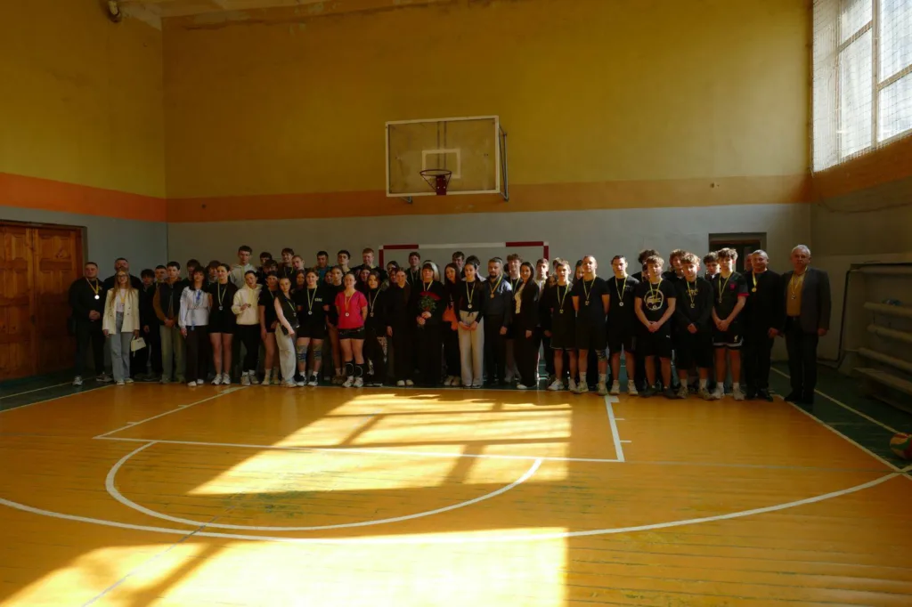 Група студентів з медалями у спортивній залі