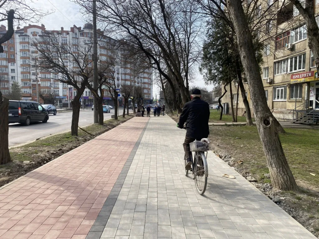 Чоловік їде на велосипеді по міській вулиці