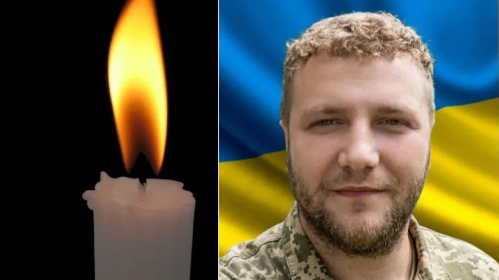 Свічка пам’яті та український військовий на тлі прапора