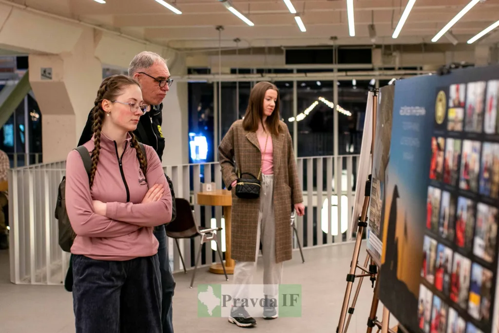 Люди оглядають фотовиставку у сучасній галереї