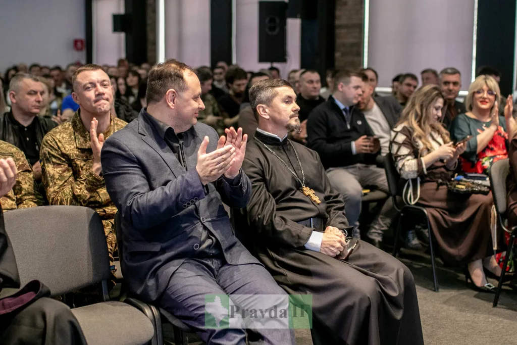 Люди аплодують на офіційному заході