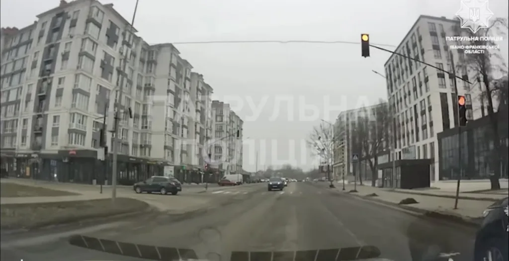 Міська вулиця з будинками та червоним світлом світлофора