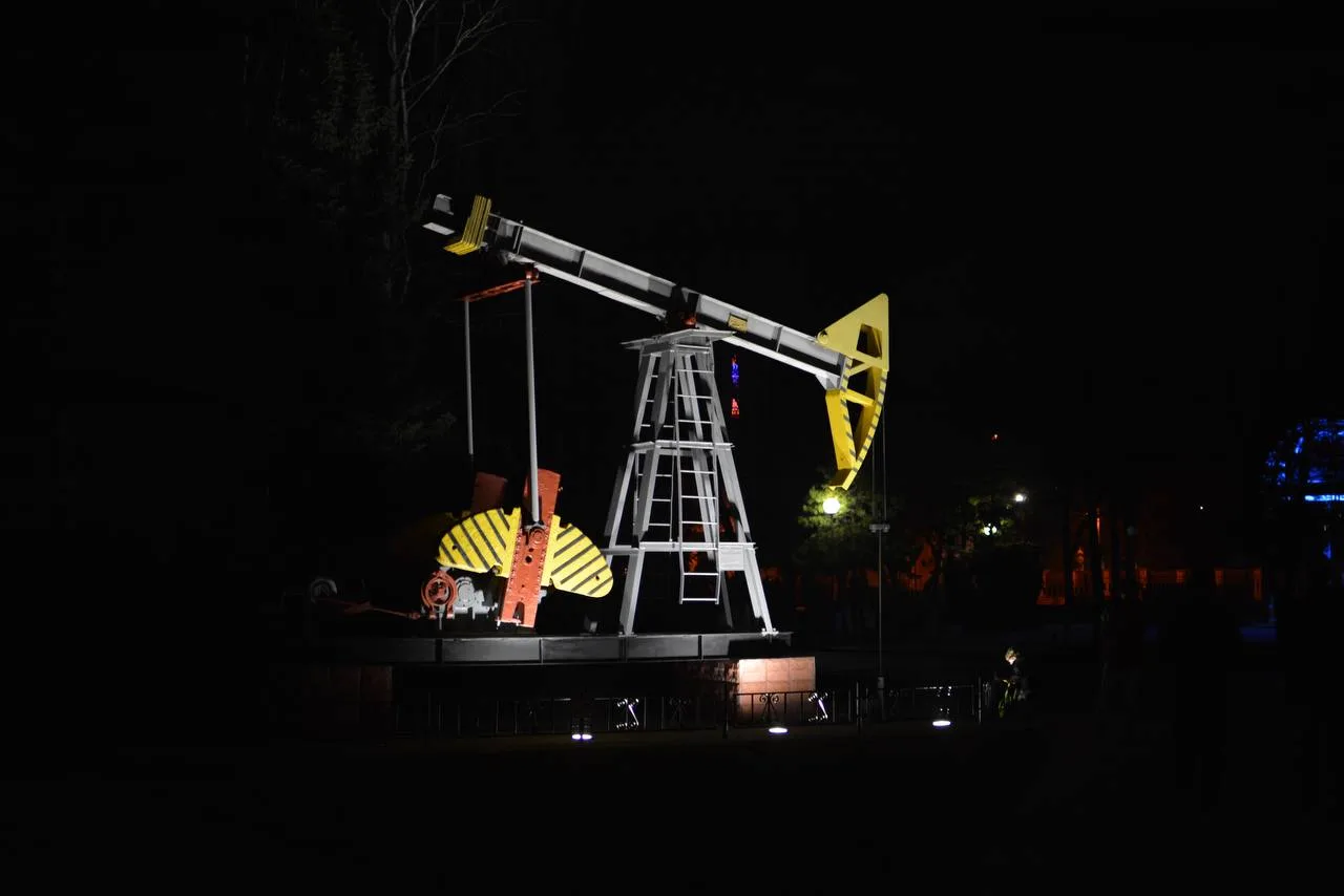 Нафтова вежа вночі освітлена ліхтарями