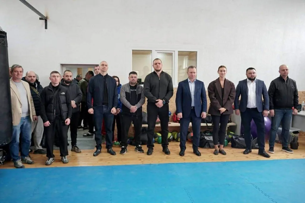 Група людей стоїть у спортивному залі