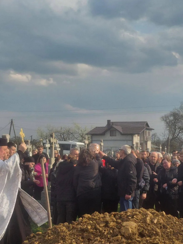 Люди на кладовищі під час похорону