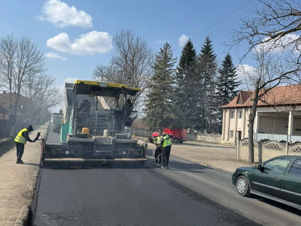 Робітники укладають новий асфальт на міській дорозі