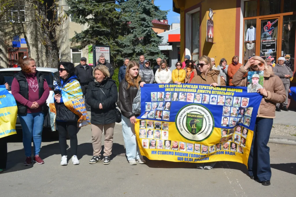 Люди тримають банер на вуличному заході підтримки