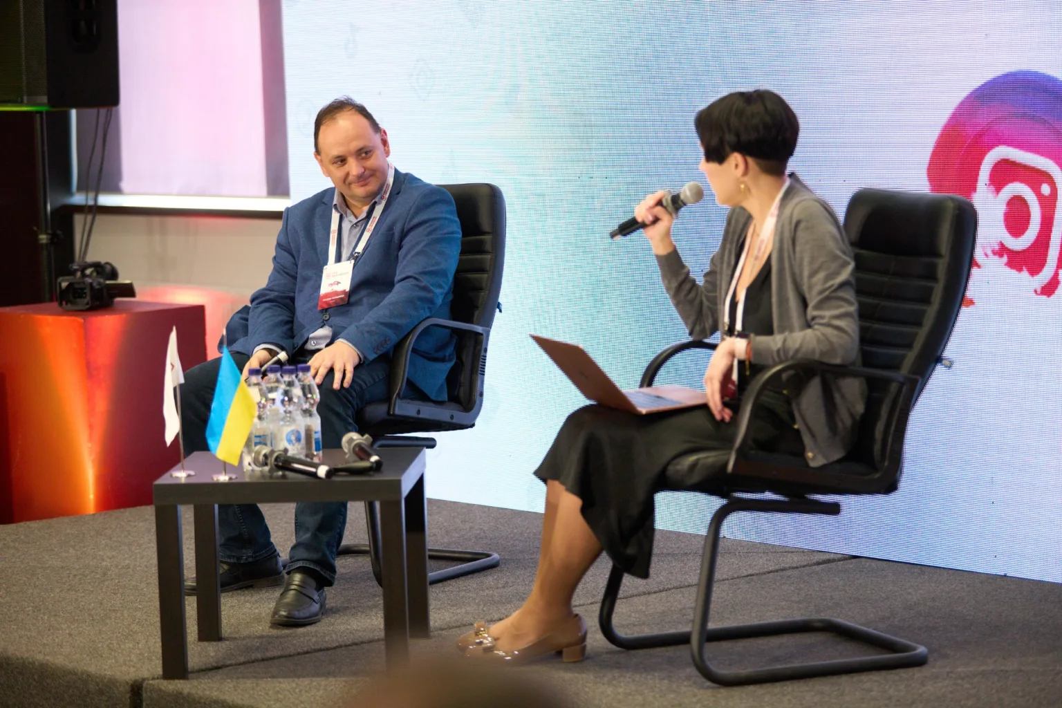 Двоє людей обговорюють тему на конференції