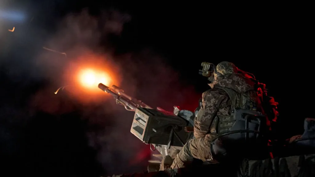 Військовий стріляє з гармати вночі