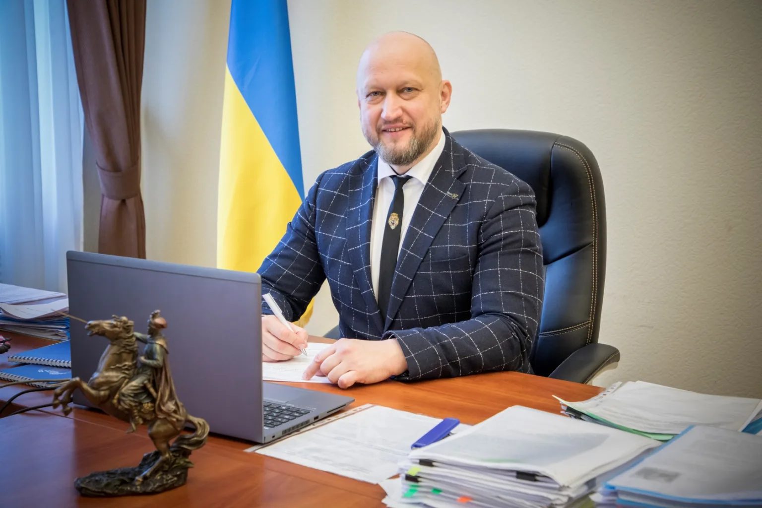 Чоловік у кабінеті працює за комп’ютером