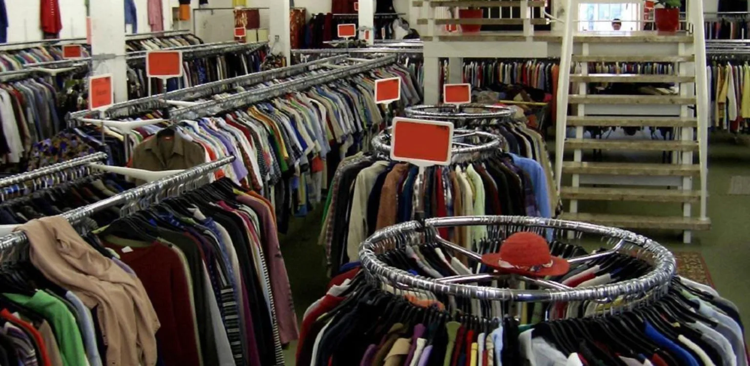 Магазин секонд-хенд з одягом на вішалках